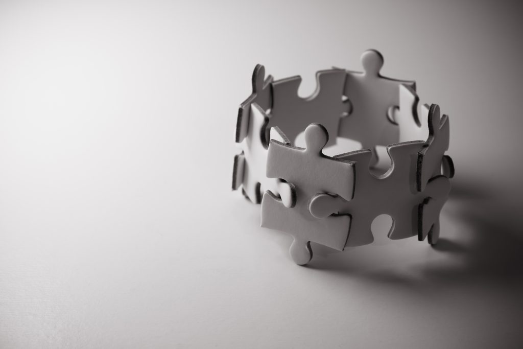 Jigsaw puzzle concept teamwork. Team building help and support concept.